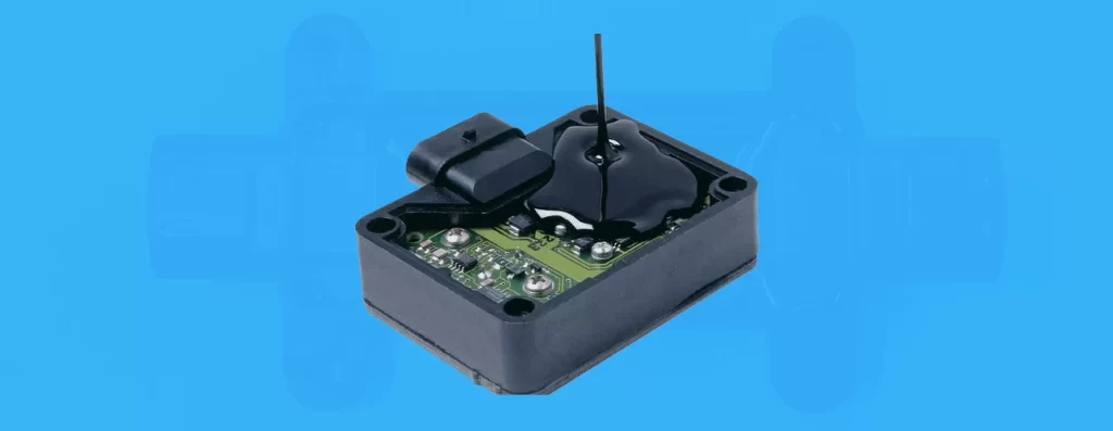 Fully encapsulated PCB module with black epoxy potting resin providing moisture, shock, and vibration protection for automotive electronics