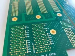 Close-up detail of 36-layer communication backplane PCB showing backdrilled vias, high-density connector pads, and precision impedance-controlled differential pair routing