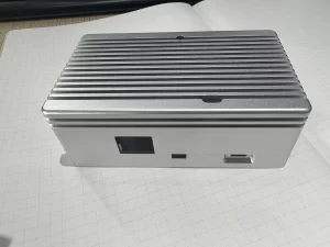 Close-up detail view of AL6061 CNC-machined enclosure for Raspberry Pi CM4 industrial applications showing bead-blasted surface finish, precision mounting holes, I/O cutouts, and integrated EMI shielding grooves