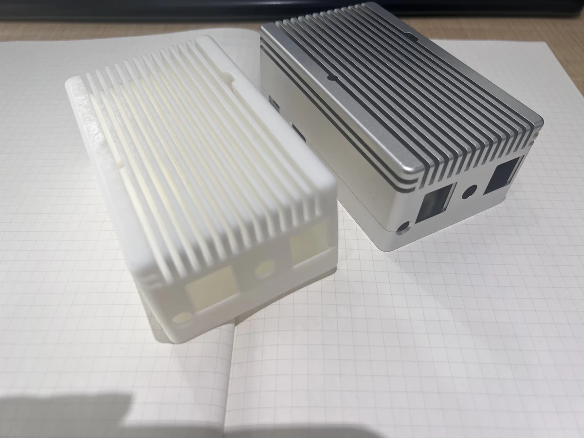 Side-by-side comparison of AL6061 CNC-machined vs. 3D-printed enclosures for Raspberry Pi CM4 industrial applications showing precision surface finish, tolerances, and durability differences