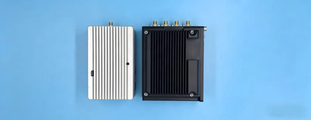 Finished PCBA fully integrated into an industrial enclosure during final production introduction of EMS box build assembly – visible RF cable and connectors, mounting points, and completed solder joints.